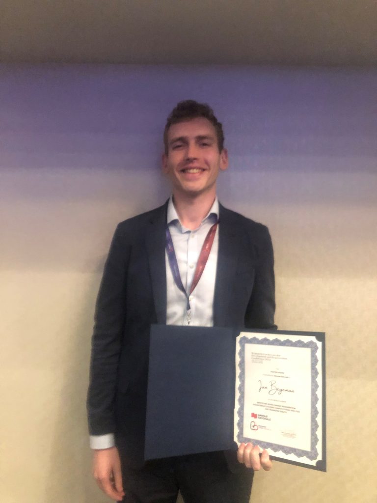 Student with medal and certificate at business event. 