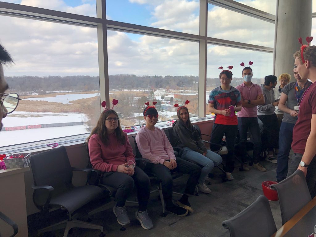 Four students wearing heart headbands for a Valentine's Day party. 